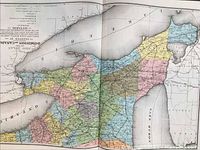 Open map page showing colored county regions within the Dominion of Canada and Lanark County, circa 1880