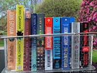 Photo of 14 books lined up with titles and authors visible.
