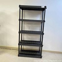 Front view of black 5 level plastic storage shelf with grid shelves