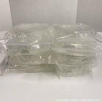 Top view of the 8 sealed rolls of clear double sided tape stacked together.