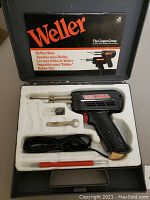 View of complete Weller soldering gun kit arranged in custom foam case with Weller branded case lid.