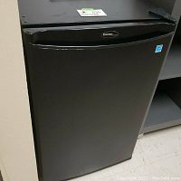 Front view of closed mini fridge showing black finish and Danby logo