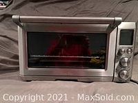 Breville convection smart oven front view with closed glass door showing control panel.