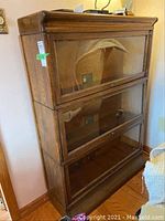 Front view of three stacked sections with glass-fronted doors closed