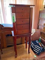 Front view of wooden standing jewelry box with four drawers