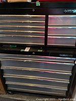 Front view of stacked top and bottom chests showing drawer arrangement