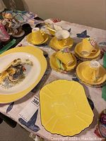 James Kent Ltd yellow tea set cups, saucers, dessert plates and Limoges turkey platter on table