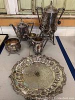 Group of five silver-plated pieces: coffee urn, teapot, creamer, sugar bowl and serving platter