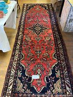 Full-length view of runner showing red ground, central medallion and border