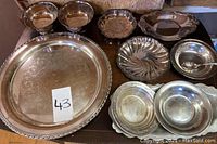 Full view of silverplated lot showing large tray, bowls, and dishes.
