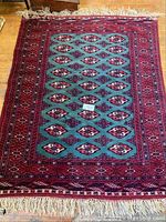 Full view of rectangular rug showing central field and borders