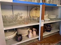 Overall shelf with ceramic and glass dishes plus figurines