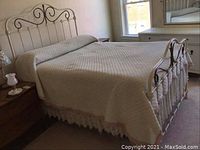 Full bed view showcasing headboard, footboard, and quilt on bed