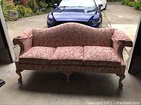 Front view of Ethan Allen couch showing rose damask fabric, carved wooden legs, and overall shape. Shows worn fabric on cushions and seat area.