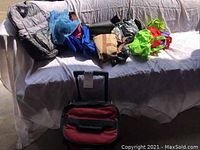 Wide shot showing all travel bags and cooler on and near couch.