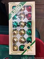 Box of 18 vintage Pyramid Jumbo Christmas ornaments including gold, green, and red colors