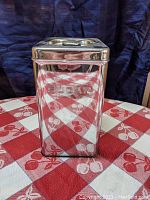 Front view of the rectangular stainless steel sugar canister with embossed 'SUGAR' label.