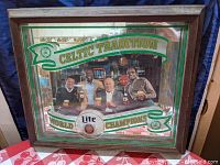 Full front view of the vintage Miller Lite Boston Celtics shadow box mirror with visible wood frame and Celtics championship years banner.