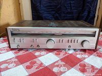 Front view of Kenwood KR-710 stereo receiver showing control panel and tuning window.