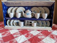Full view of the opened box showing all 38 pieces of the Pfaltzgraff Yorktowne tea set neatly arranged inside.
