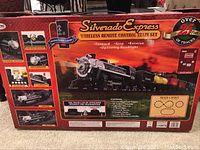Box front showing the Silverado Express Wireless Remote Control Train Set with track layout and features including forward, stop, reverse and operating headlight