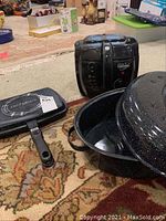 Presto Cool Daddy deep fryer with lid and small black toaster visible on carpet.