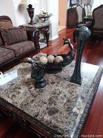 Wide photo showing all three items on marble table near couch in living room setting