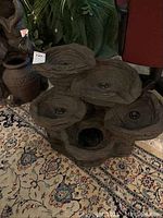 Full view of the multi-bowl water feature showing the natural stone look and textured surface with multiple small ponds arranged vertically.