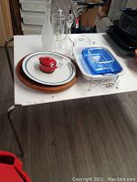 Overview of lot: serving bowl on wood tray, mini pot, bakeware and decanters