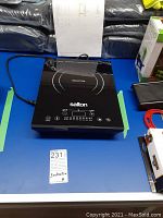 Top view of Salton induction cooktop, shows power cord and control panel.