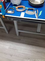 Four manual cutters laid out on a table showing different blade shapes and wooden handles