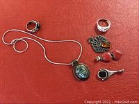 Overview of all items including necklace, three pendants, two rings