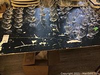 Overview of multiple arranged glass stemware on table showing variety and quantity.