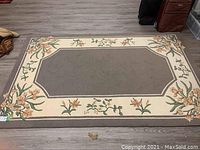 Full view of the wool carpet showing the entire design and condition on the floor.