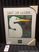 Framed art print "The Wetlands" by P. Michele showing full piece with protective corner covers on frame, featuring a white bird with yellow beak and wetland background