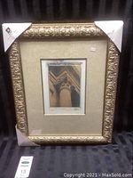 Full view of the framed artwork with ornate gold frame and corner protectors.