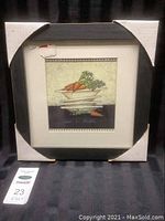 Full view of the framed art with protective cardboard corners.