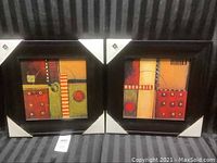 Photo showing two square framed abstract art pieces side by side with black frames and colorful geometric designs.