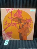 Full view of the square canvas art showing two Asian women in traditional clothing in front of a large yellow sun and pink foliage on a peach background.