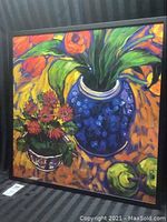 Full view of framed colorful still life giclee print featuring flowers in blue vase and fruit on orange surface