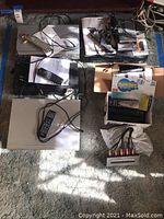 Overview of multiple electronic devices including various models in silver casings with remotes and cables.