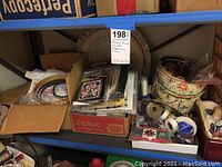 Shelf view of needlepoint threads, patterns, baskets, and storage bags