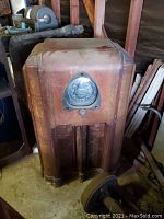 Front view of the Zenith radio console showing large round dial and wooden cabinet with scratches and wear.