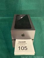 Top of sealed Apple iPhone 6S Plus box showing front graphic and Space Gray color