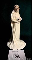 Full view of Royal Doulton Bride figurine standing on a surface with tag number 126.