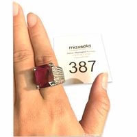 Hand wearing a size 8 silver ring with an extra large square red ruby stone and decorative silver band detail.