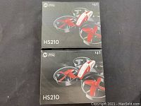 Two unopened Holy Stone HS210 drone boxes stacked