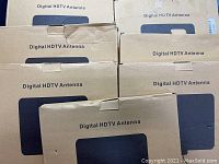 Seven cardboard boxes labeled Digital HDTV Antenna stacked together.