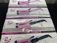 Four boxed packages of Junma Professional Three-Rod Curlers, sealed and stacked showing front packaging with product photo and branding.