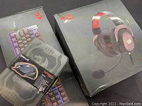 Three items: gaming keyboard in box, Centrophorus gaming mouse in plastic packaging, and wired gaming headset in box with Redragon branding.